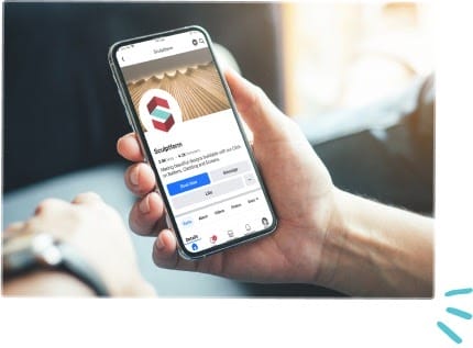 A person holds a smartphone displaying a Facebook page for "Sculpteam," featuring a logo, cover photo, and profile details. Sunlight shines in the background, creating a bright, modern atmosphere.