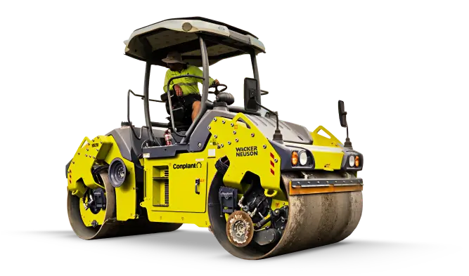 A person operates a bright yellow Wacker Neuson compactor roller, used for flattening and paving surfaces, isolated on a white background.